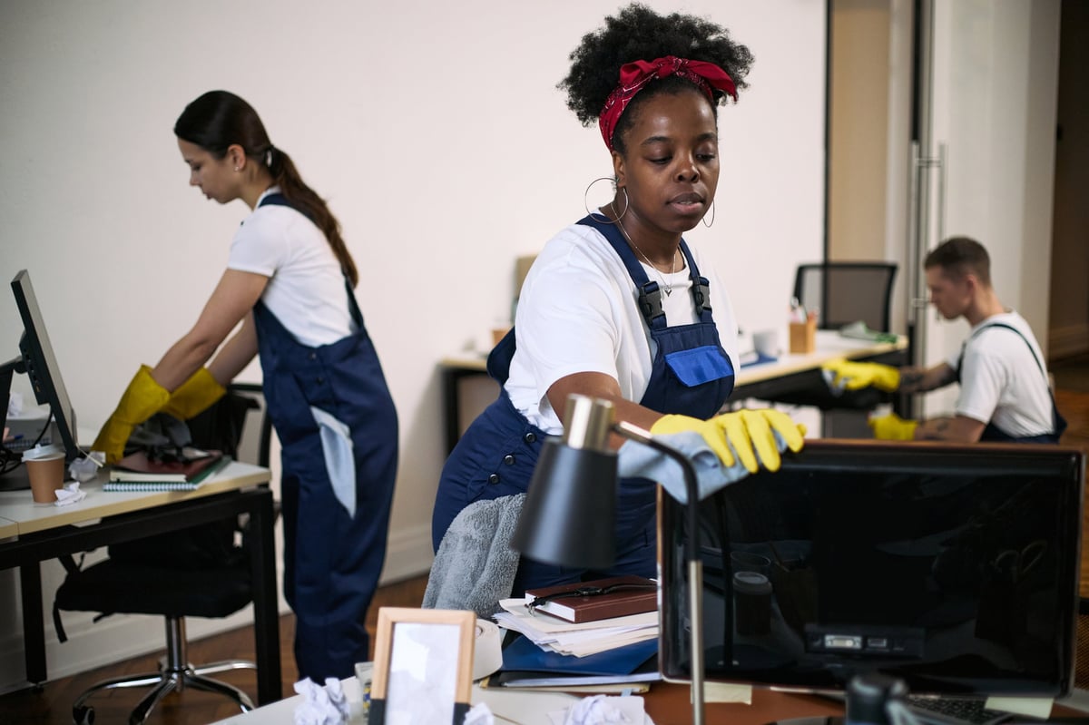 Diverse cleaning team working together in modern office
